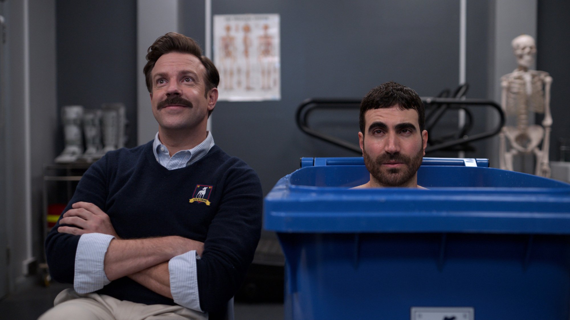 Jason Sudeikis sits beside Brett Goldstein, who sits in an ice bin, in "Ted Lasso."