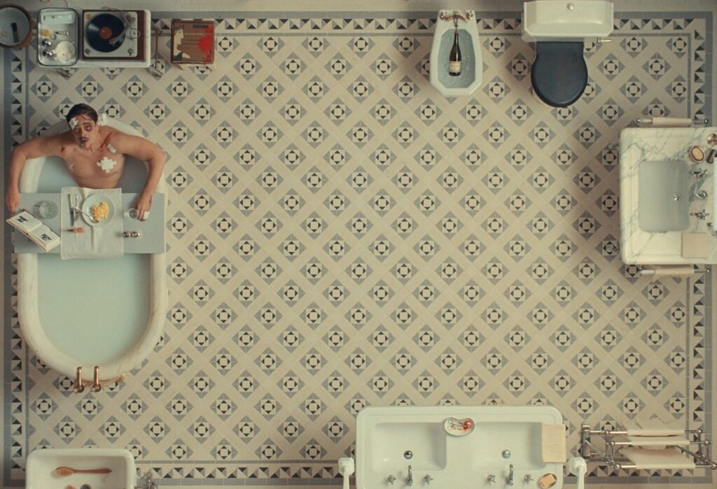 Benicio del Toro as Zsa-zsa Korda and Mia Threapleton as Liesl in director Wes Anderson
