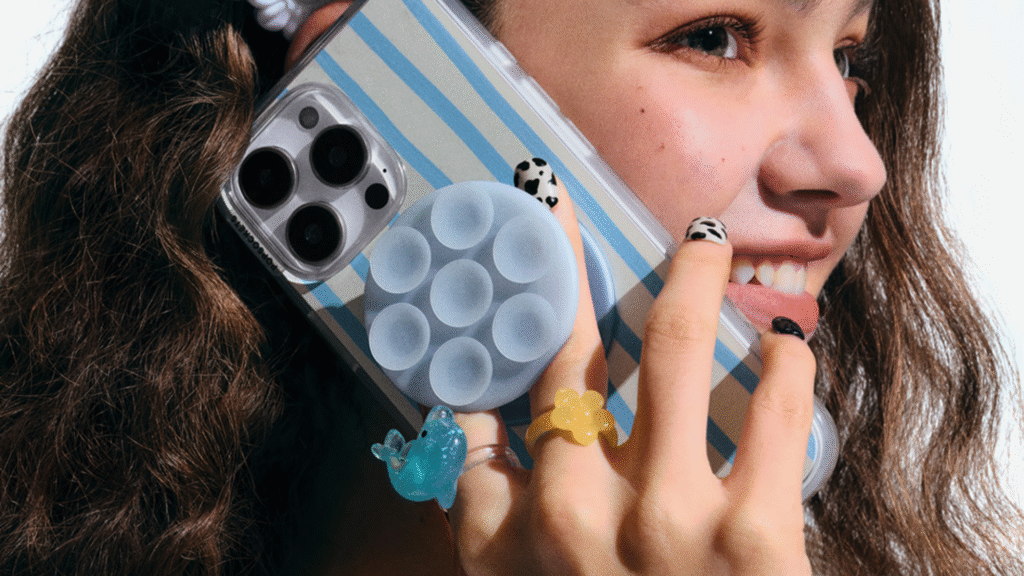 A phone with a Suck Up Popsocket grip on it.