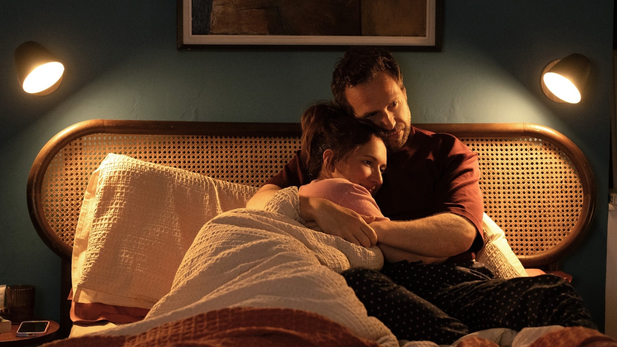 Esther Smith and Rafe Spall cuddle in bed in "Trying."