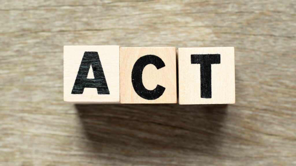 ACT letter blocks on wooden background