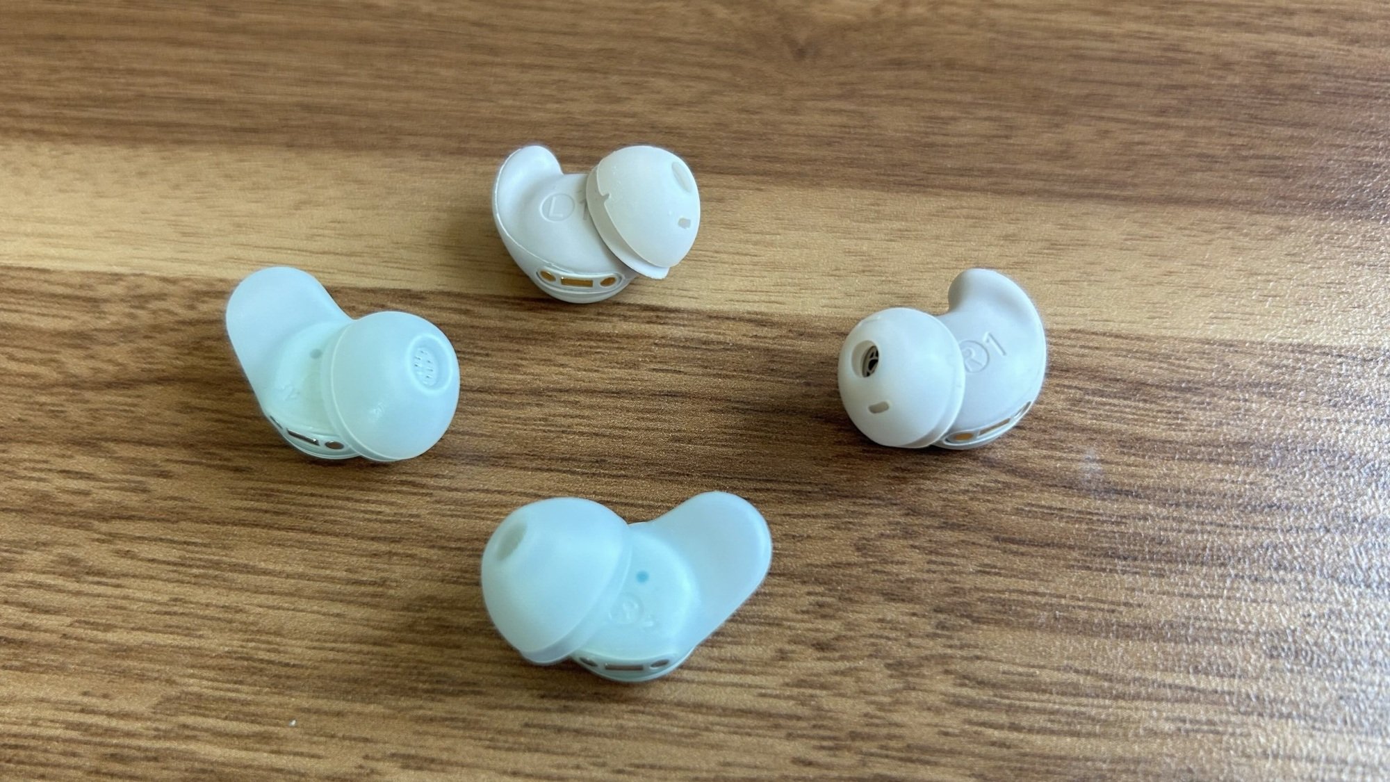 sleep a30 earbuds next to sleep a20 earbuds on desk