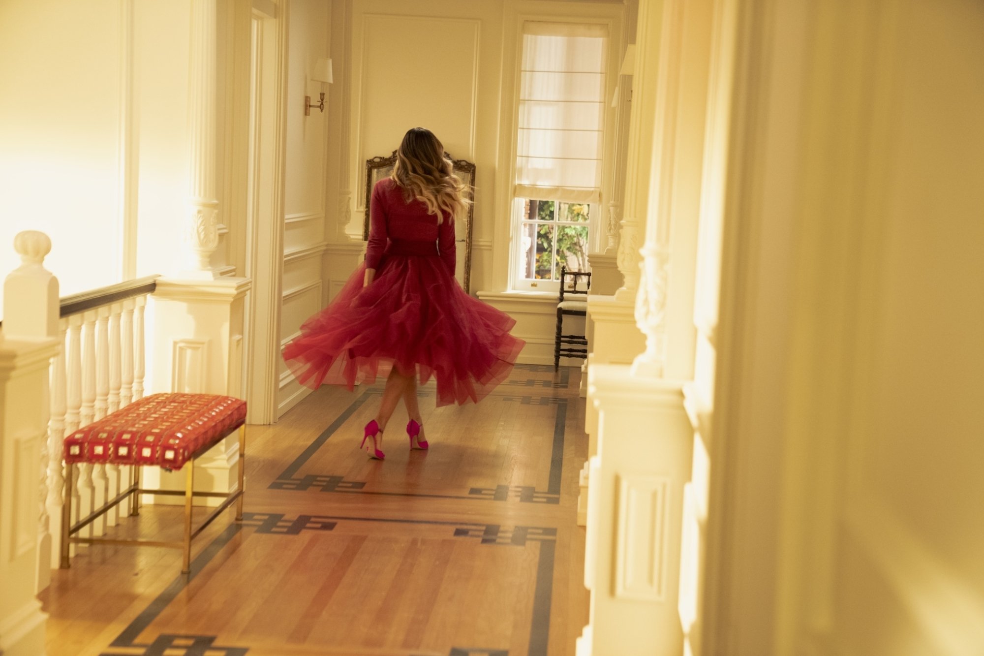 Carrie Bradshaw (Sarah Jessica Parker) twirling in a pink dress in the final episode of 'And Just Like That'