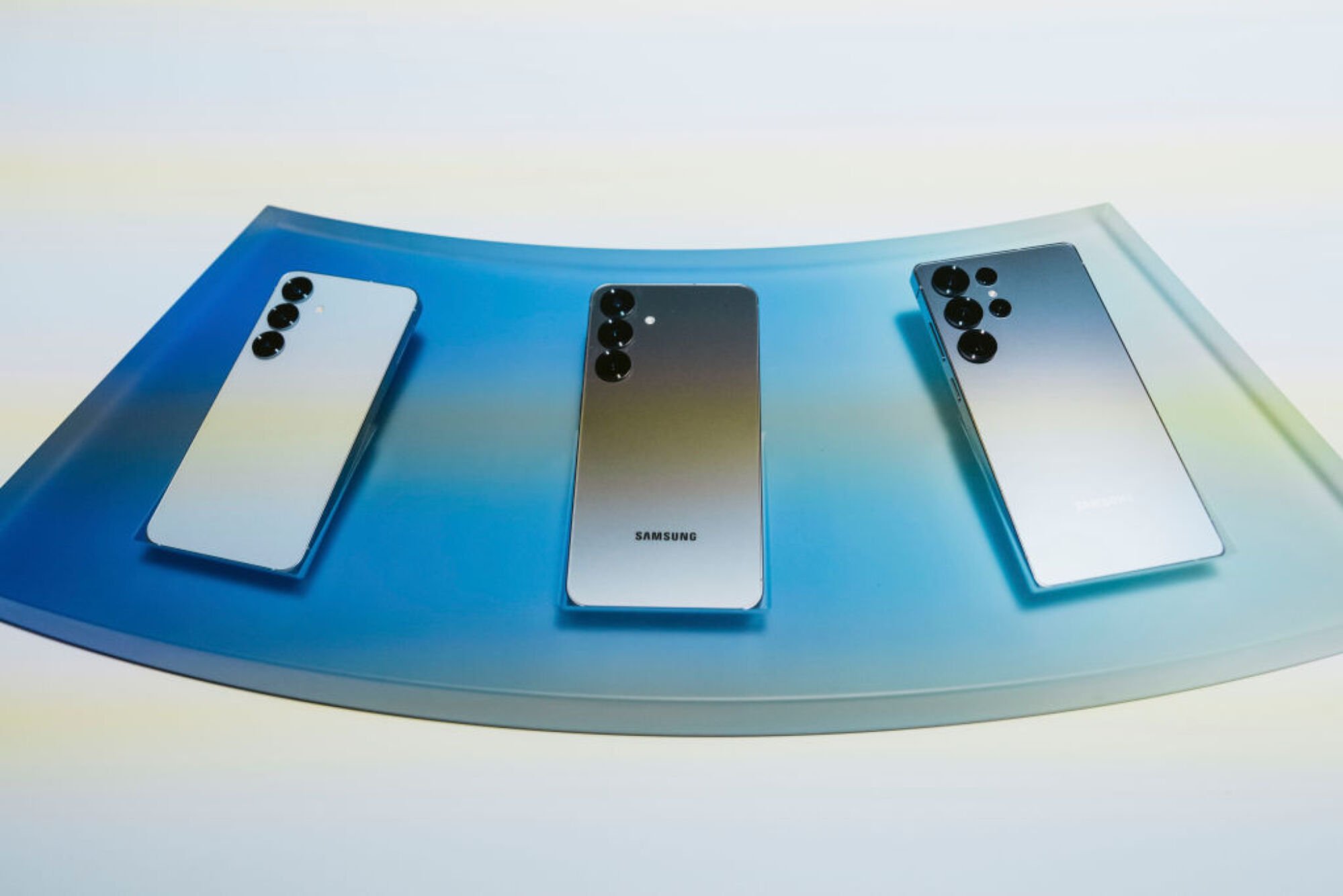 Samsung Galaxy S25 phones lined up horizontally on a table