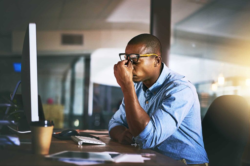Frustrated business person in front of a computer screen.