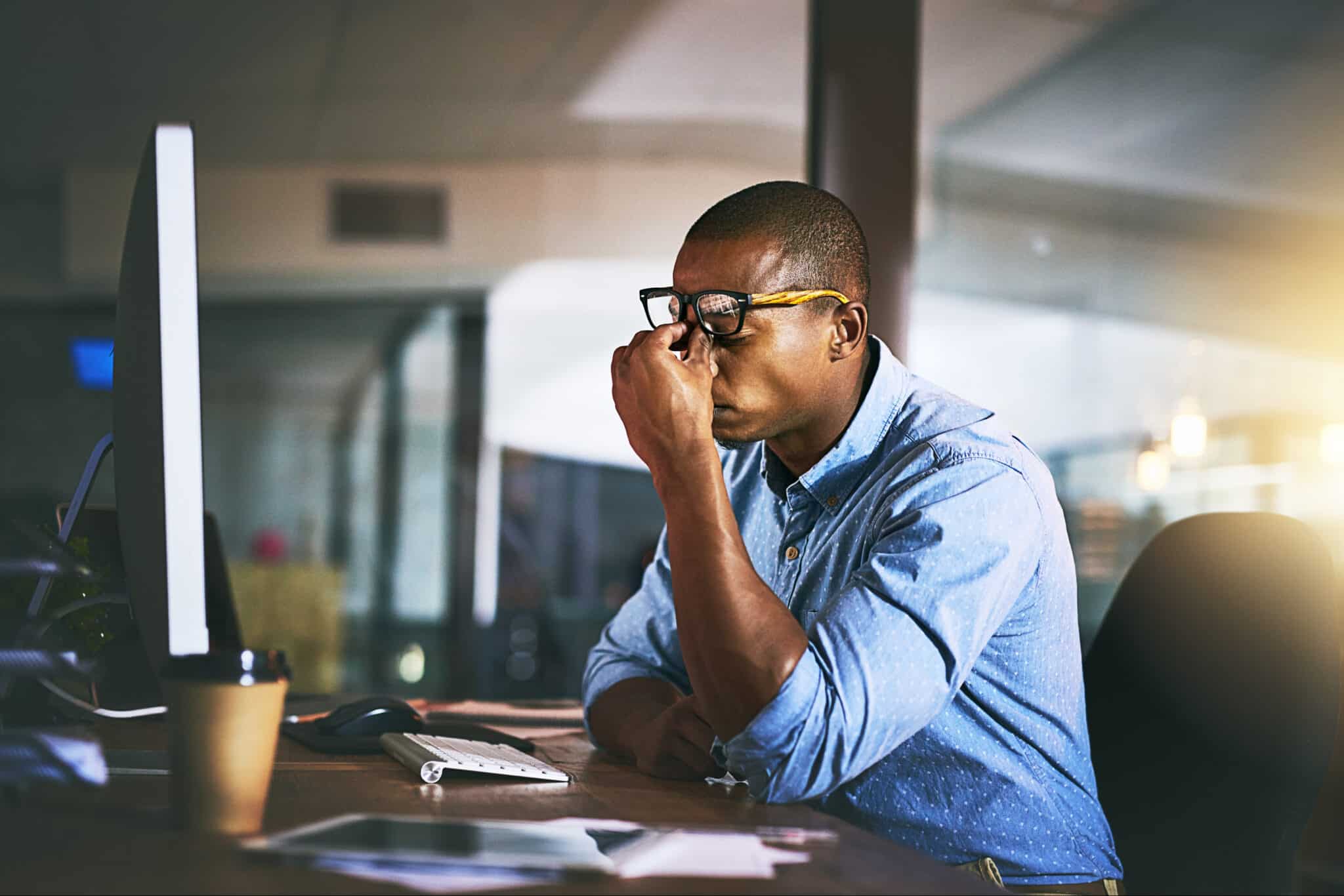 Frustrated business person in front of a computer screen.